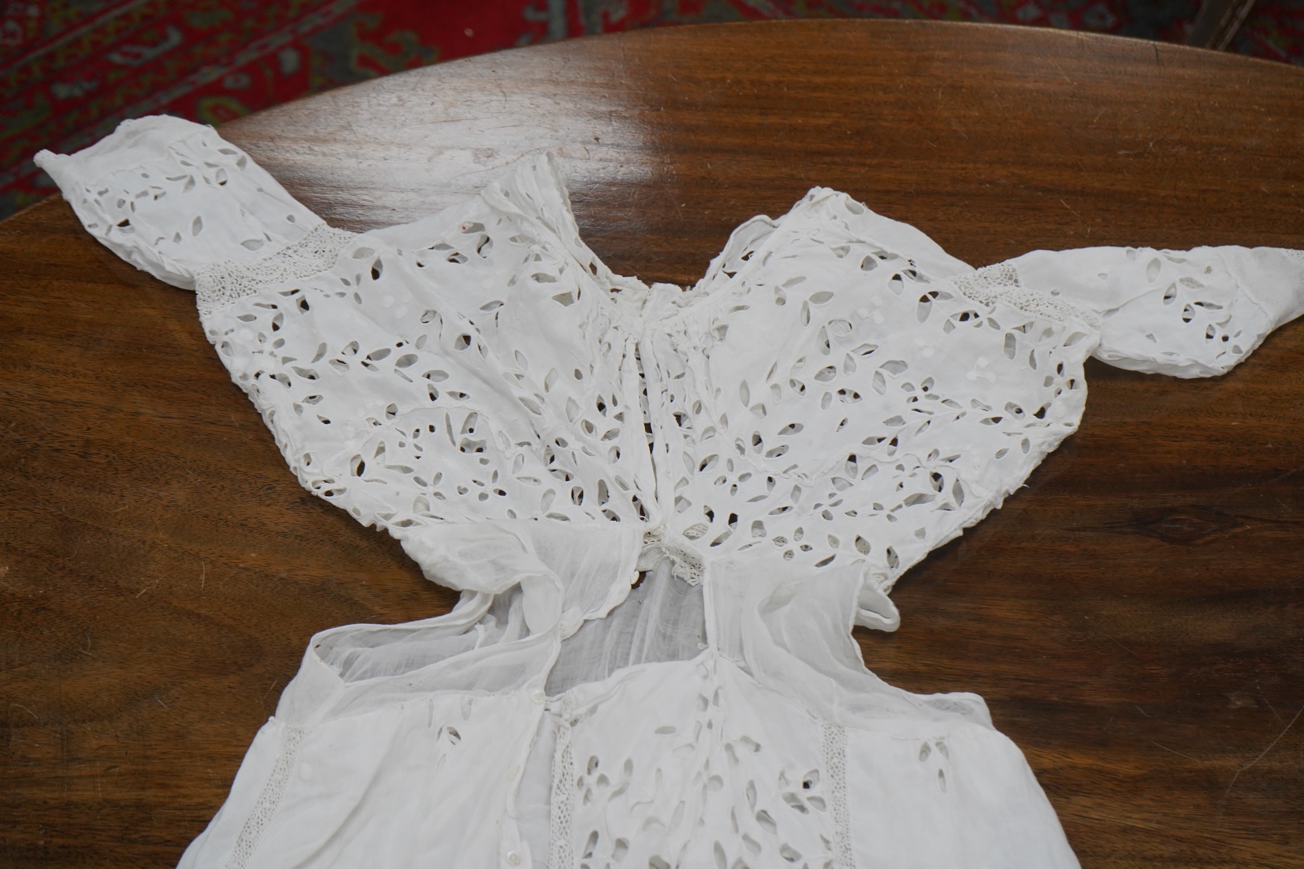 An Edwardian fine white embroidery anglaise and Irish crochet trimmed ladies summer dress, designed with large panels of anglaise cut work, the dress has been altered and restyled, which could be altered back, 134cm long